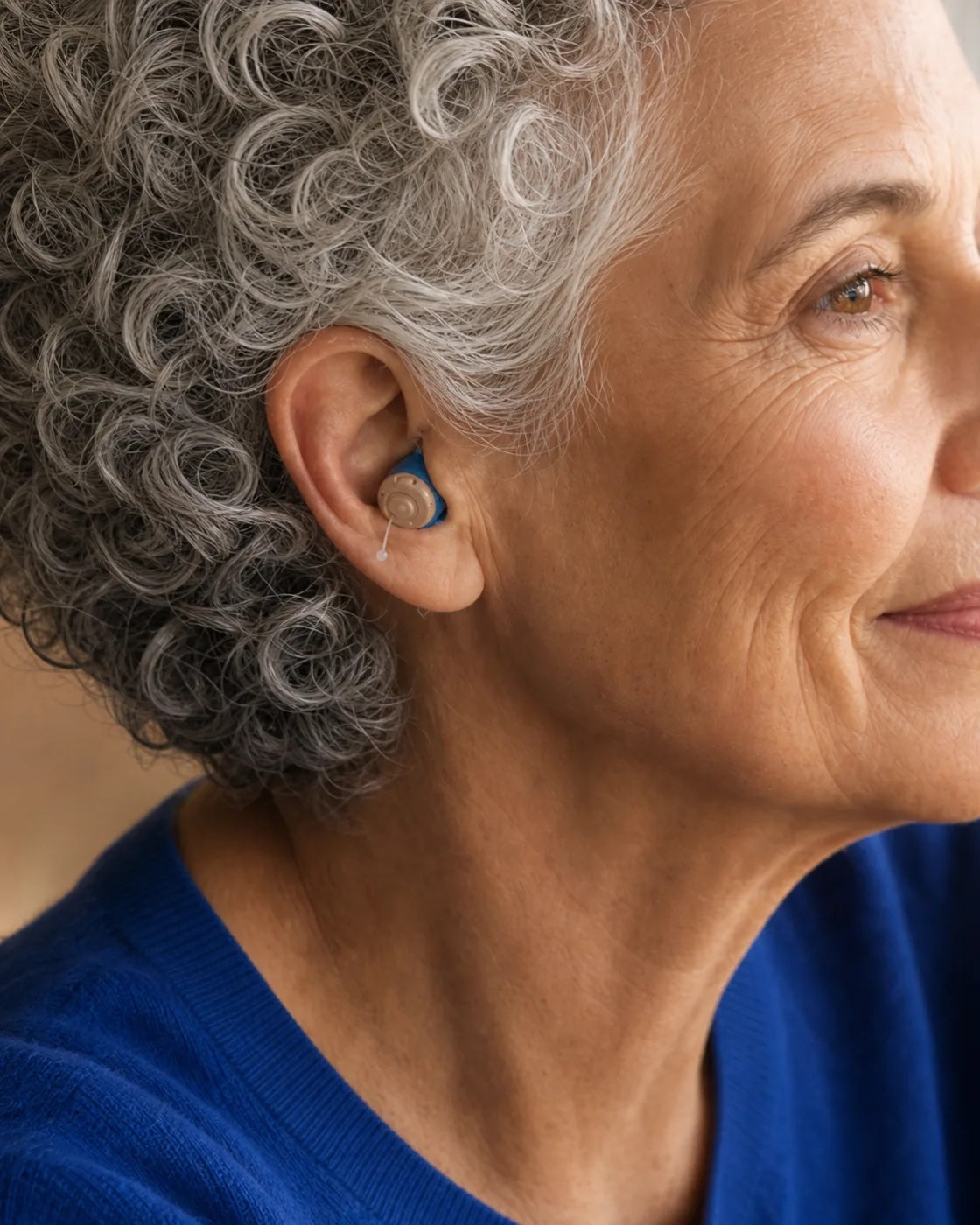 A woman wearing an Oricle hearing aid