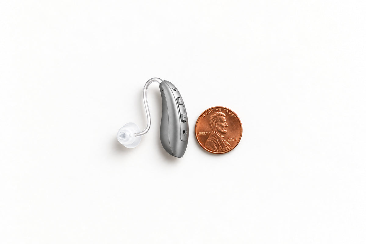 One Oricle TrueFit aid beside a US penny